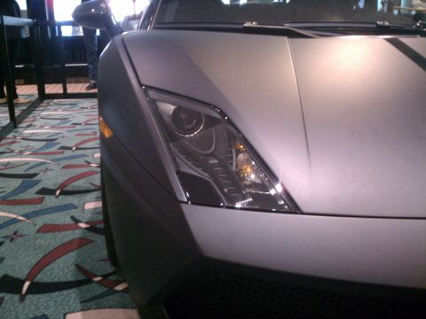1998 Toyota Camry - Close-up of a gray car's front corner, revealing headlight details and a matte finish.