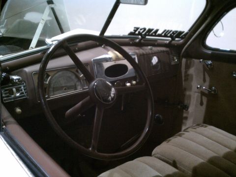 1998 Toyota Camry - The interior of a vintage vehicle shows a large steering wheel and striped upholstery, with "AMBULANCE" visible above the windshield.