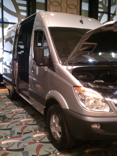 1998 Toyota Camry - Silver van with its hood and passenger door open, displayed indoors with a patterned carpet.