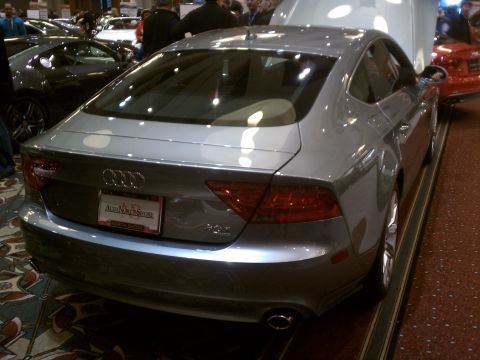 1998 Toyota Camry - Silver Audi A7 displayed at an auto show, showing its rear and part of its side profile.