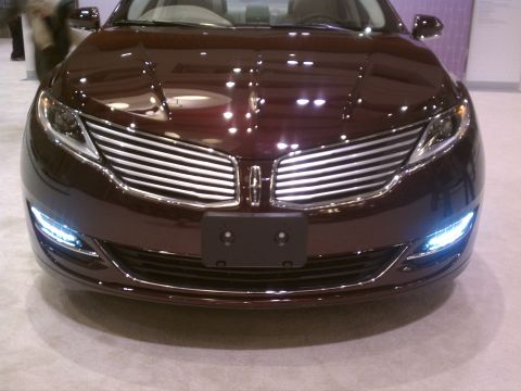 1998 Toyota Camry - A maroon Lincoln sedan is displayed at a show, its front grille and headlights prominently featured.