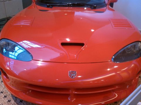 1998 Toyota Camry - The front of a red Dodge Viper is shown, its distinctive hood scoop and headlights.