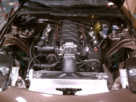 1998 Toyota Camry - Engine bay view of a V8 engine with custom modifications and brown paint.