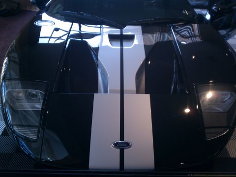 1998 Toyota Camry - Front view of a black Ford GT white racing stripes and the iconic Ford emblem.