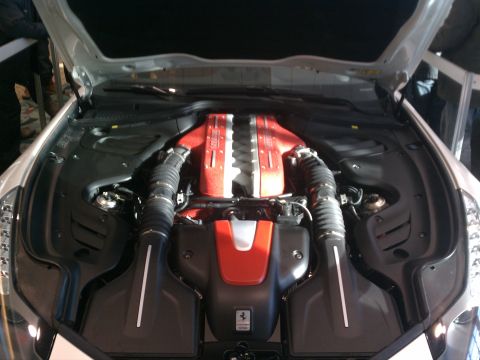 1998 Toyota Camry - The engine bay of a car, a prominent red and silver engine with dual air intakes.