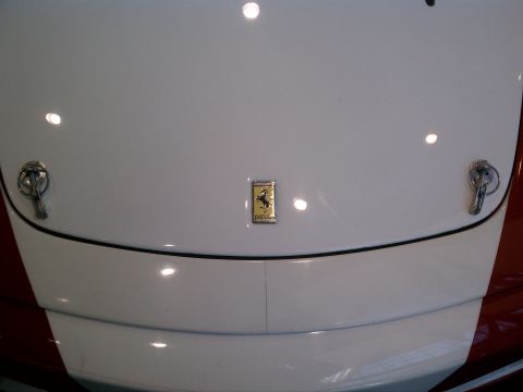 1998 Toyota Camry - Close-up of a Ferrari emblem on the hood of a white car.
