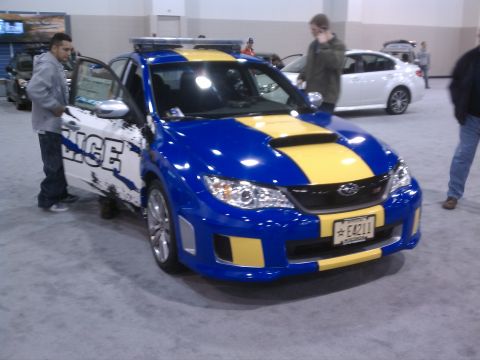 1998 Toyota Camry - A blue and yellow police car is displayed with its door open, showing "POLICE" text on the side.