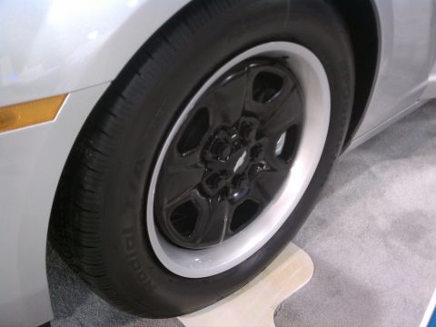 1998 Toyota Camry - Close-up of a car wheel with a black rim and a white trim ring, showing the tire tread.