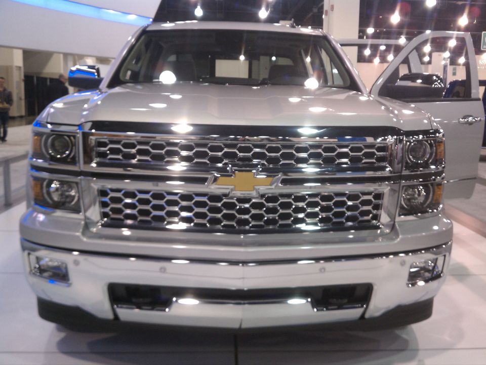 Silver Chevrolet Silverado pickup truck front grille and headlights