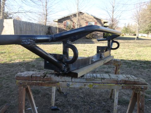 1990 Ford Bronco - Custom front bumper fabrication in progress, resting on sawhorses outdoors.