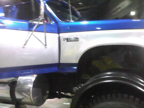 2003 Ford Crown Victoria - A blue and white Ford F-350 truck is shown from the side, with a focus on the door and fender area.