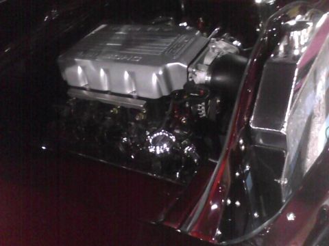 2003 Ford Crown Victoria - Close-up view of a V8 engine, likely a performance upgrade, in a vehicle's engine bay.