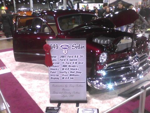 2003 Ford Crown Victoria - Customized 1949 Ford Sedan on display at an event, showing its engine and interior.