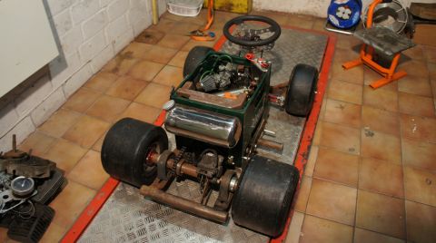 1973 Ford Ranchero - A custom-built go-kart with a visible engine and large tires sits on a platform in a garage.