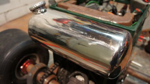 1973 Ford Ranchero - Close-up of a shiny chrome fuel tank and mechanical components of a go-kart.