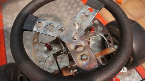1973 Ford Ranchero - Steering wheel and front axle of a go-kart, showing mechanical components.
