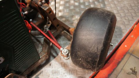 1973 Ford Ranchero - Close-up of a go-kart's front wheel and suspension system.