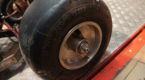 1973 Ford Ranchero - A close-up view of a go-kart's wheel and tire, showing the tread and rim detail.