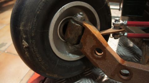 1973 Ford Ranchero - Close-up of a wheel and its rusty suspension assembly.
