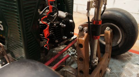 1973 Ford Ranchero - Close-up view of a go-kart's engine and front wheel assembly, highlighting its mechanical components and suspension.