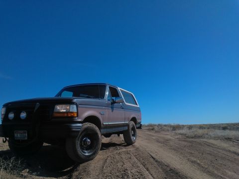 1992 Ford Bronco - Ford Bronco navigates a dusty trail on a clear day.