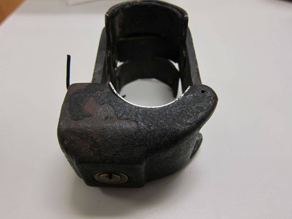 Black metal siren part with keyhole
