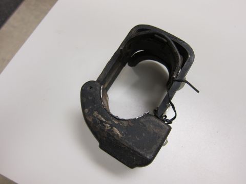2001 Ford Crown Victoria - A close-up view of a worn black metal bracket, likely a component from an emergency vehicle's lighting system.