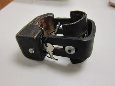 2001 Ford Crown Victoria - A close-up view of a metal clamp with a key.