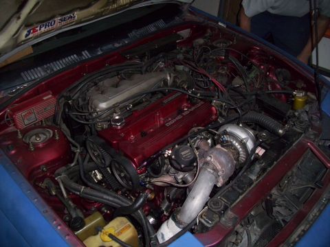 1995 Ford Probe - The engine bay features a prominent turbocharger and custom red valve cover with 'DOHC 16 VALVE' text.