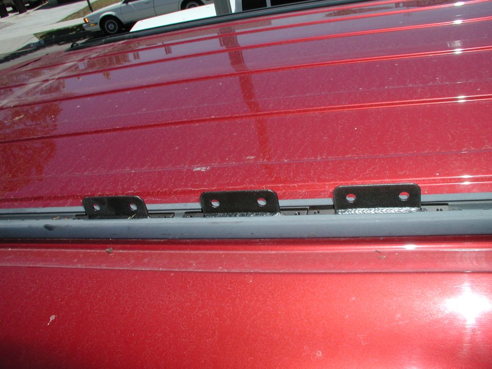 Mounting tabs for brackets slide into rails and screw for wedge fit to hold in place.