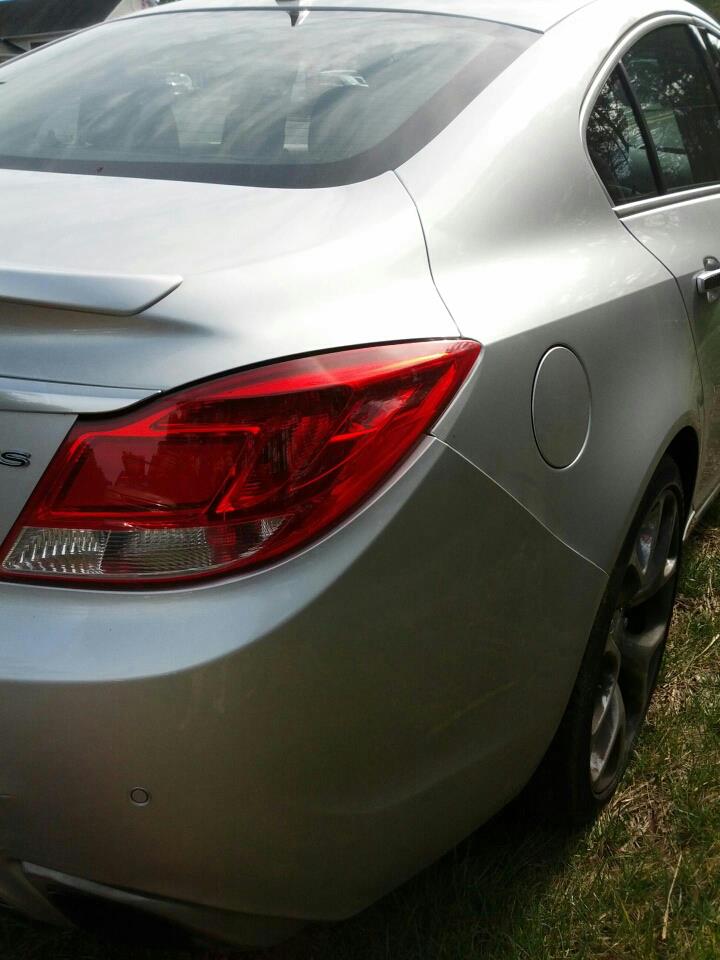 Rear quarter panel and taillight of a silver sedan