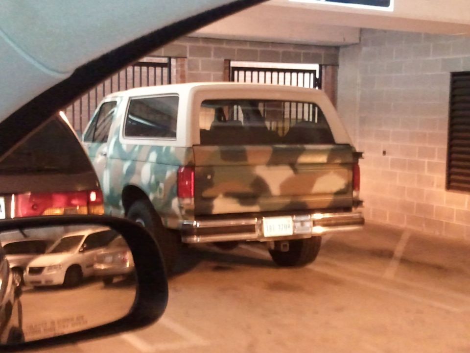 Rear view of a 1994 Ford Bronco with camouflage paint