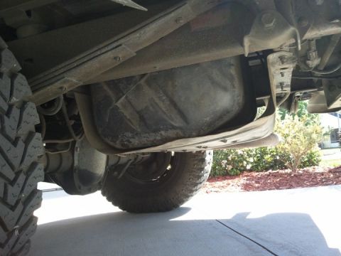 1994 Ford Bronco - The fuel tank and rear suspension components are visible from underneath the vehicle.