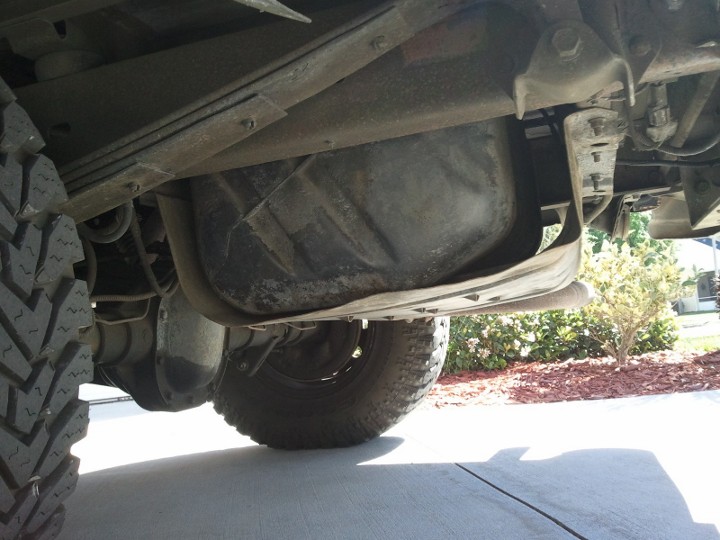Underside view of a vehicle's fuel tank and leaf spring suspension