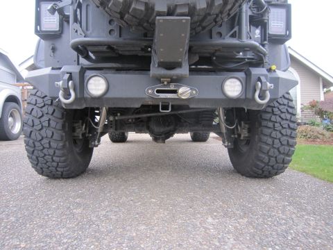 2008 Jeep Wrangler - The rear of a heavily modified Jeep shows off its aftermarket bumper, winch, and LED lighting.