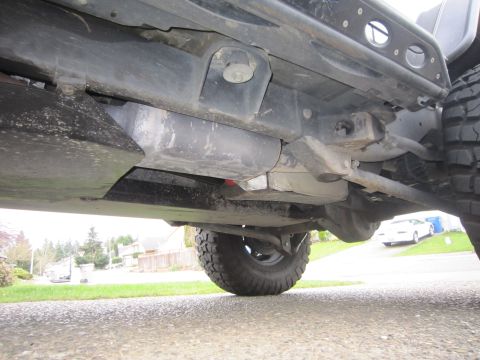 2008 Jeep Wrangler - The undercarriage of a 2008 Jeep Wrangler is visible, highlighting its suspension components and fuel tank.