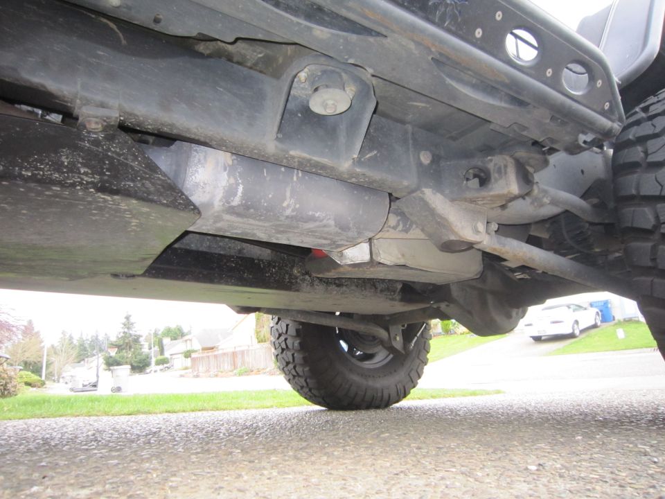 Undercarriage of a 2008 Jeep Wrangler showing suspension and fuel tank