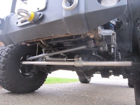 2008 Jeep Wrangler - Aftermarket steering components on a Jeep Wrangler, including a steering stabilizer and tie rod.