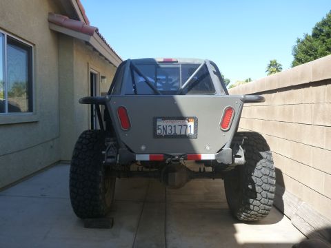1997 Ford Ranger - Custom off-road truck with a roll cage and oversized tires is parked in a driveway.