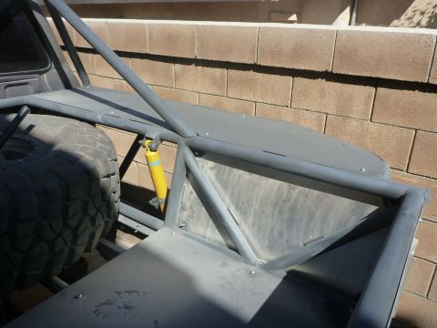 1997 Ford Ranger - Custom roll cage and spare tire mounted in the bed of an off-road vehicle.
