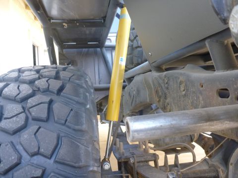 1997 Ford Ranger - Close-up of a large off-road tire and suspension system, with visible "SUPERMOTORS" text.