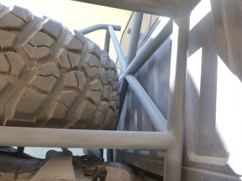 1997 Ford Ranger - Spare tire and roll cage are visible inside the bed of a truck.