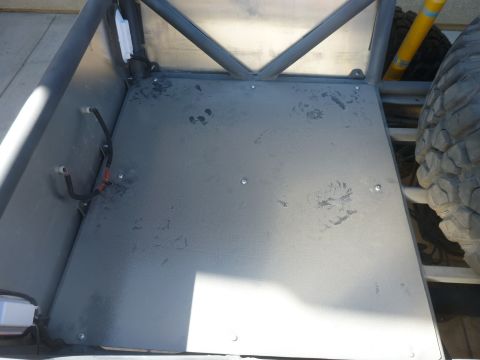 1997 Ford Ranger - The interior of a custom-built off-road vehicle features a metal floor and a prominent roll cage structure.
