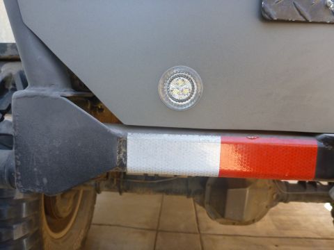 1997 Ford Ranger - Close-up of a truck's rear section, showing a light and reflective tape on the bumper.