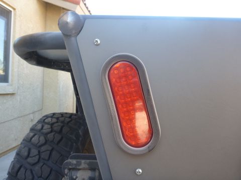 1997 Ford Ranger - Close-up of a truck's rear corner, showing a modern LED taillight and a custom roll bar.