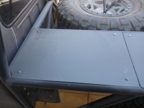 1997 Ford Ranger - The interior of a custom off-road vehicle shows a spare tire mounted above a metal storage platform.