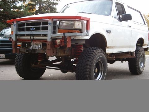1995 Ford Bronco - This 1995 Ford Bronco features a custom front bumper and a significant lift kit, giving it an aggressive stance.