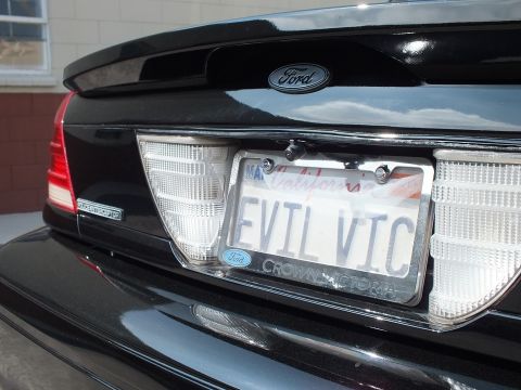 2003 Ford Crown Victoria - Close-up of a black Ford trunk lid, EVIL VIC California plate and Crown Victoria frame