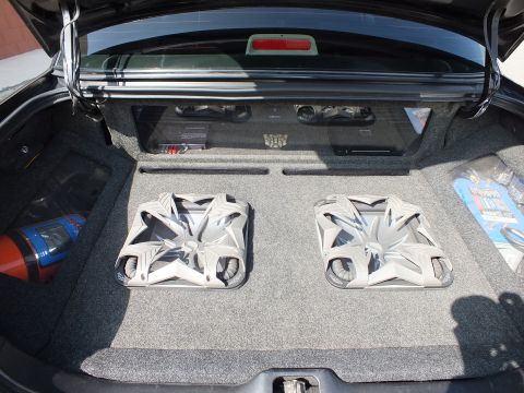 2003 Ford Crown Victoria - Trunk audio install: two pale subwoofers in a fabricated box with amp and chrome trim bar overhead