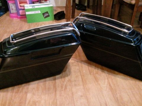 1995 Ford F-150 - Two dark green motorcycle saddlebags with chrome accents are shown on a wooden floor.